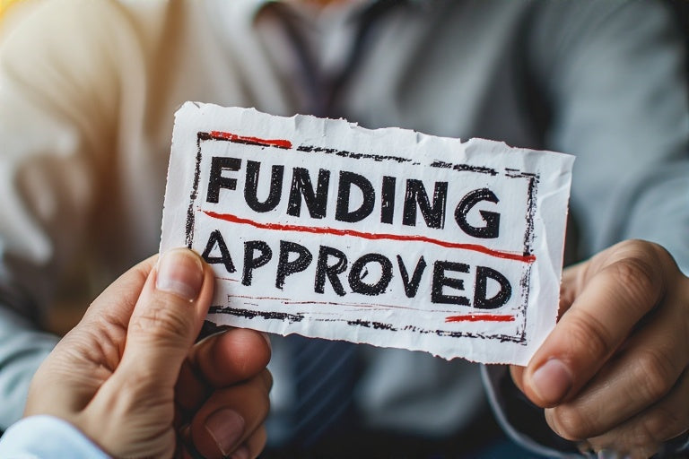 Funding approved sign held by person representing credit repair with funding buildout digital product
