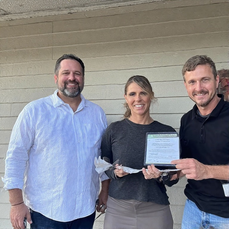 Three people smiling and holding a document representing full credit repair services by The 777 Club