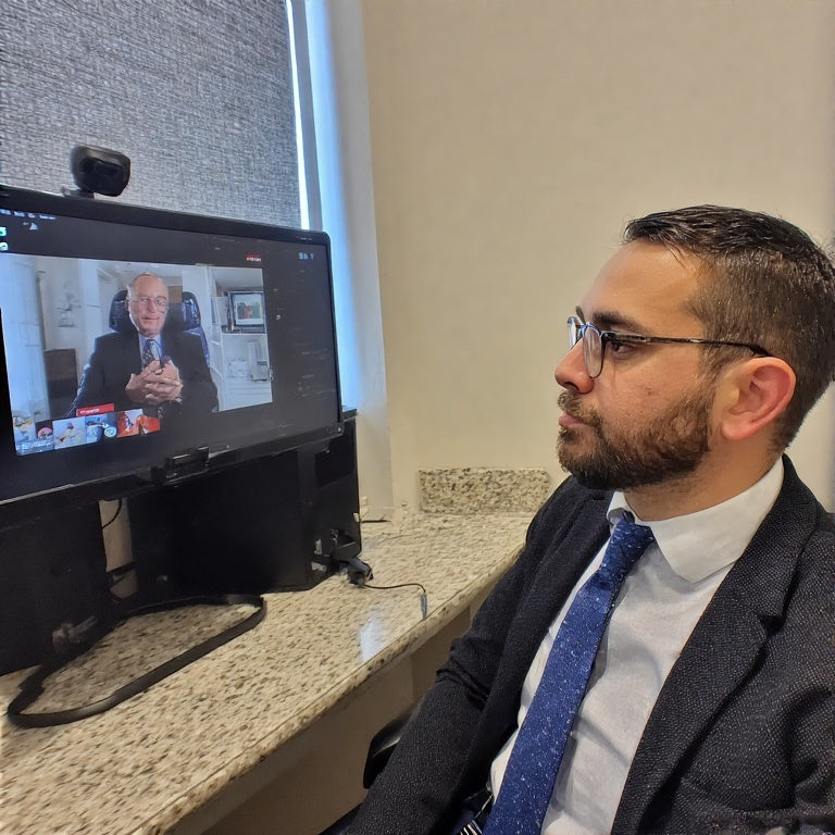 Man in suit having a 1-on-1 credit improvement call on a computer video conference