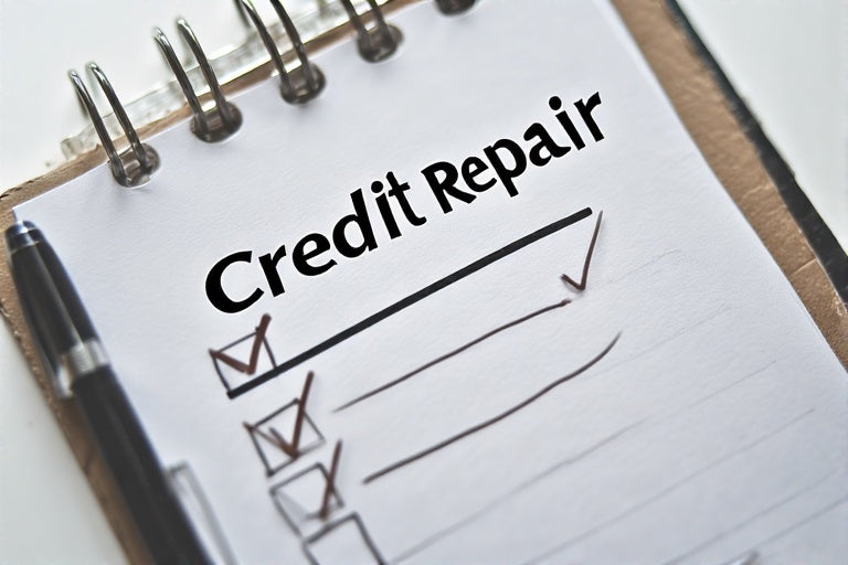 DIY credit repair guide checklist with pen and spiral notebook for credit repair planning