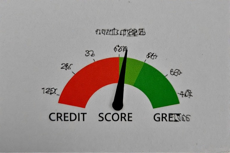 Credit score gauge showing improvement from red to green indicating benefits of full credit repair services